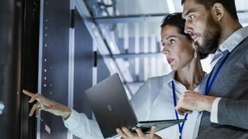 people using laptop in a data center