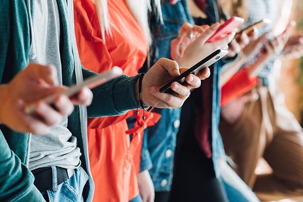group of people checking mobiles