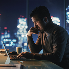 Man working on a laptop at night.