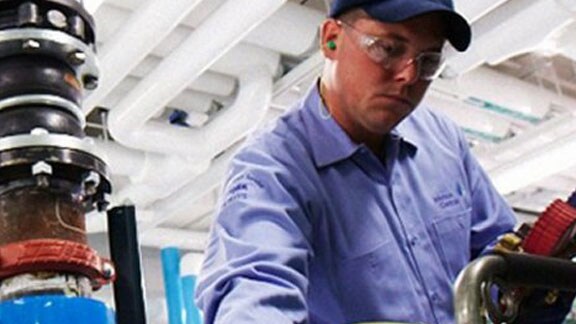 man inspecting machine cap