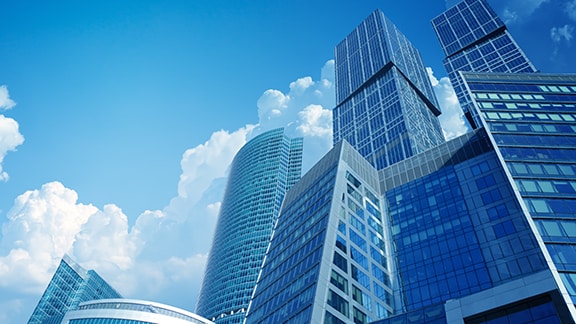 Skyscrapers with blue glass windows against a daytime sky